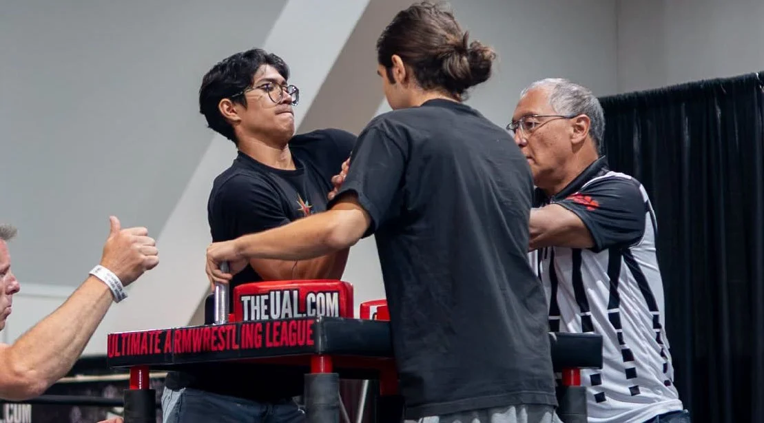 Two arm wrestling competitors competing at the UAL Olympia Armwrestling Championship